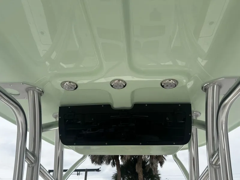 Slide: The Image of 2024 Pioneer 220 Bay Sport boat interior ceiling with lights and support poles. - 23