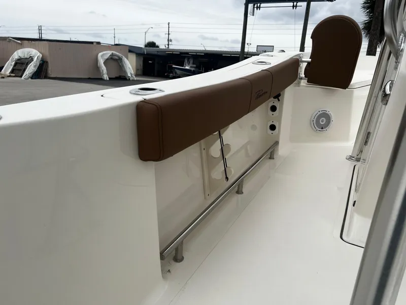 Slide: The Image of 2024 Pioneer 220 Bay Sport boat interior with brown seating and white deck. - 25