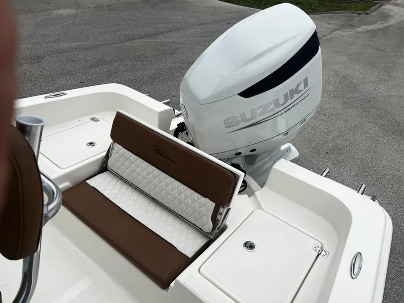 Slide: The Image of 2024 Pioneer 220 Bay Sport boat with Suzuki outboard motor and cushioned seating. - 26