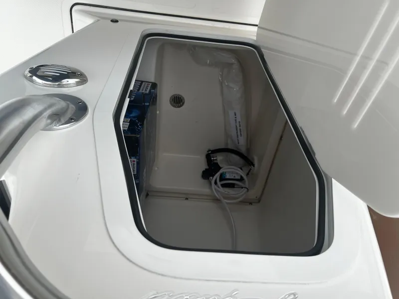 Slide: The Image of Open storage compartment in 2024 Pioneer 220 Bay Sport boat. - 28