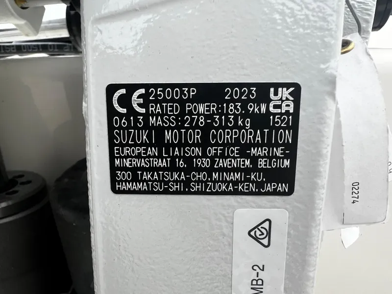 Slide: The Image of Label on Suzuki motor, 2023, showing power and mass details. - 37