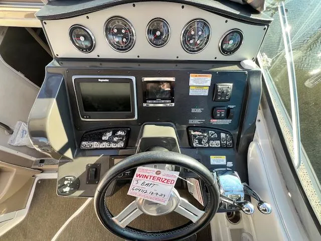 Slide: The Image of 2017 Sea Ray 330 Sundancer dashboard with gauges, controls, and winterization notice. - 11