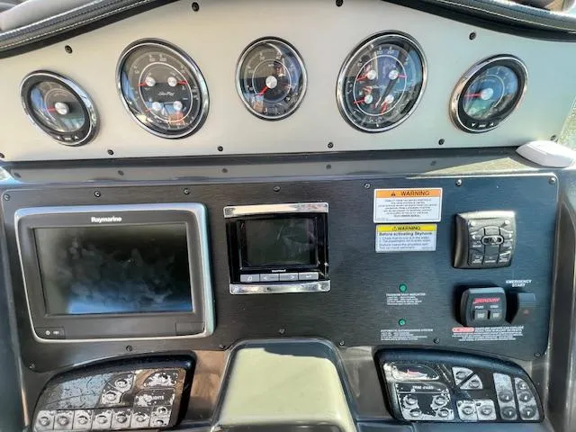 Slide: The Image of Dashboard of a 2017 Sea Ray 330 Sundancer boat with gauges and navigation equipment. - 12