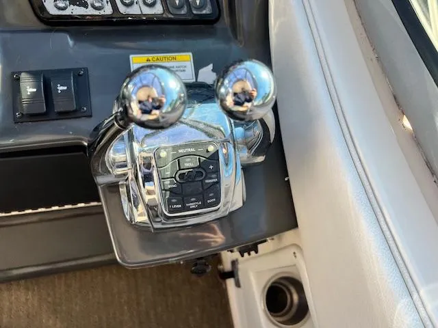 Slide: The Image of Throttle controls on a 2017 Sea Ray 330 Sundancer boat dashboard. - 14