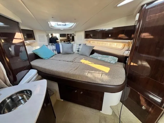 Slide: The Image of 2017 Sea Ray 330 Sundancer cabin interior with bed, skylight, and modern furnishings. - 17