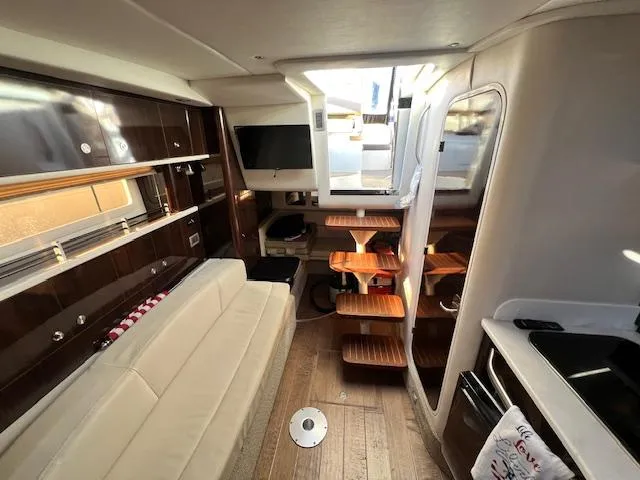 Slide: The Image of Interior of 2017 Sea Ray 330 Sundancer yacht with modern furnishings and wooden accents. - 24