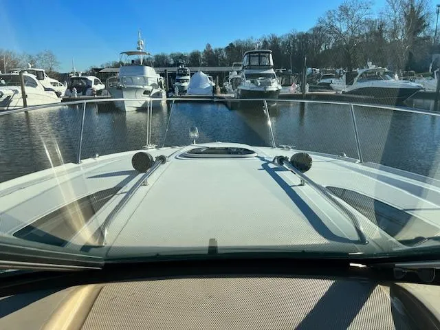 Slide: The Image of 2017 Sea Ray 330 Sundancer docked in a marina with other boats. - 25