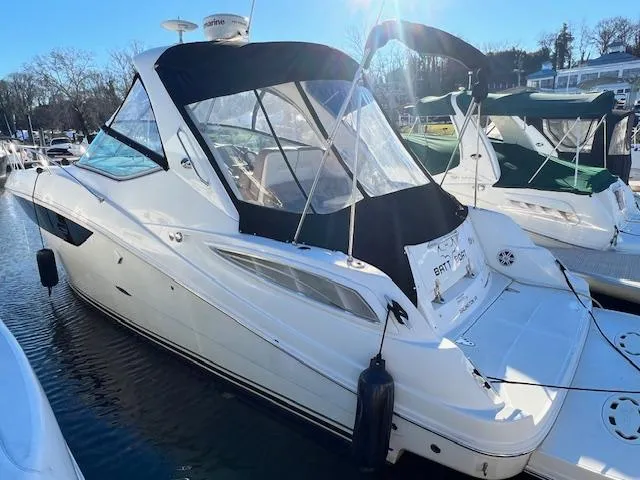 Slide: The Image of 2017 Sea Ray 330 Sundancer yacht docked in marina, featuring sleek design and black canopy. - 3