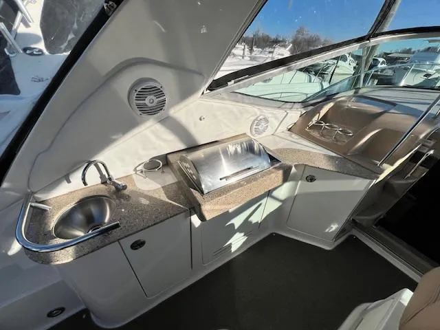 Slide: The Image of 2017 Sea Ray 330 Sundancer interior with kitchenette, sink, and grill. - 6