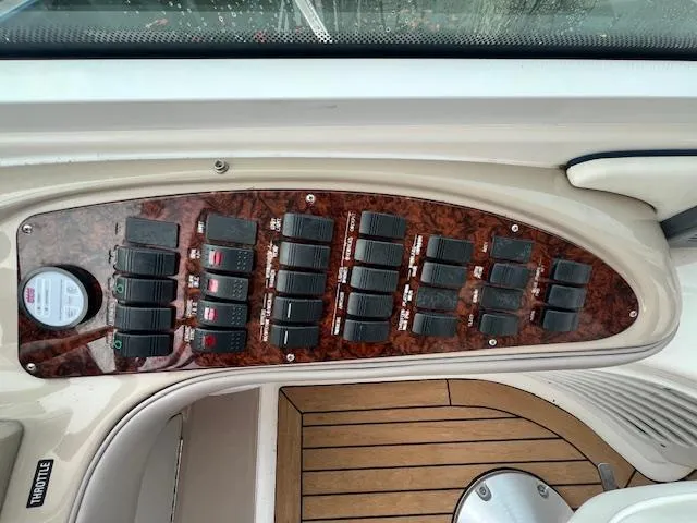 Slide: The Image of Control panel of a 2005 Sea Ray 500 Sundancer yacht with wood finish and switches. - 13