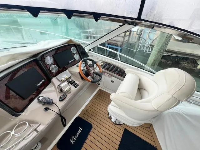 Slide: The Image of Helm of 2005 Sea Ray 500 Sundancer yacht with luxurious seating and advanced navigation controls. - 16