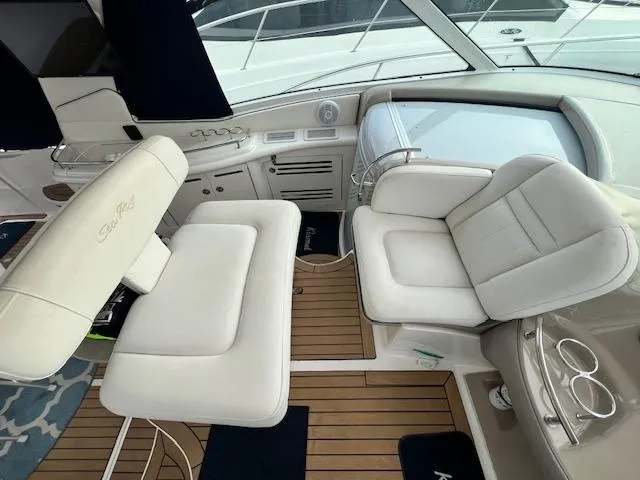Slide: The Image of Interior of 2005 Sea Ray 500 Sundancer with white leather seating and wooden flooring. - 17