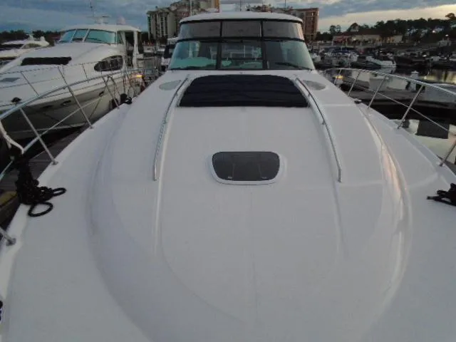 Slide: The Image of 2005 Sea Ray 500 Sundancer yacht docked at marina, showcasing sleek deck design. - 18