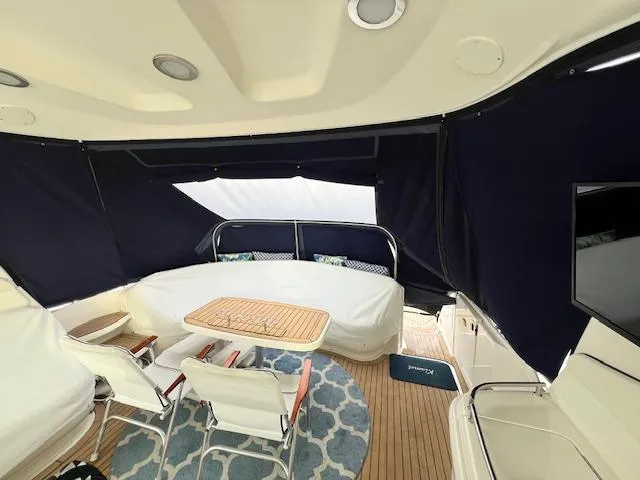 Slide: The Image of Interior of 2005 Sea Ray 500 Sundancer yacht with seating and table. - 21