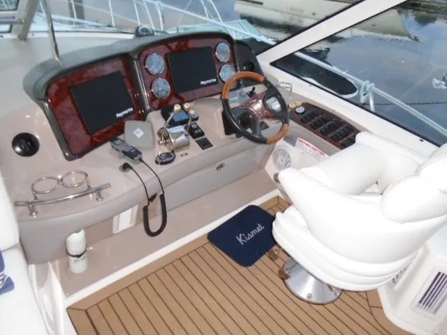 Slide: The Image of 2005 Sea Ray 500 Sundancer helm with modern controls and comfortable captain's chair. - 25