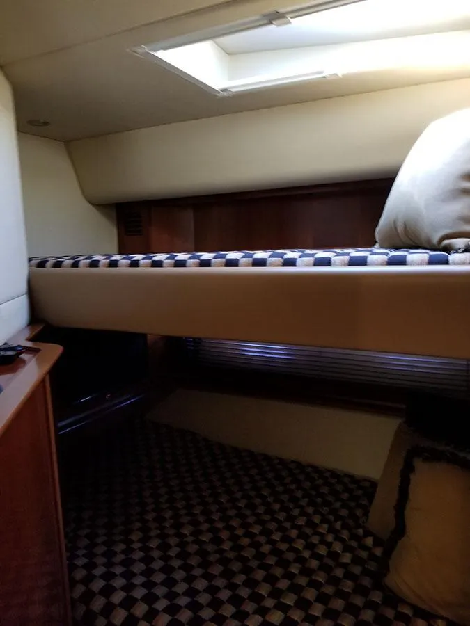 Slide: The Image of Interior cabin of 2005 Sea Ray 500 Sundancer yacht with bunk beds and checkered flooring. - 28