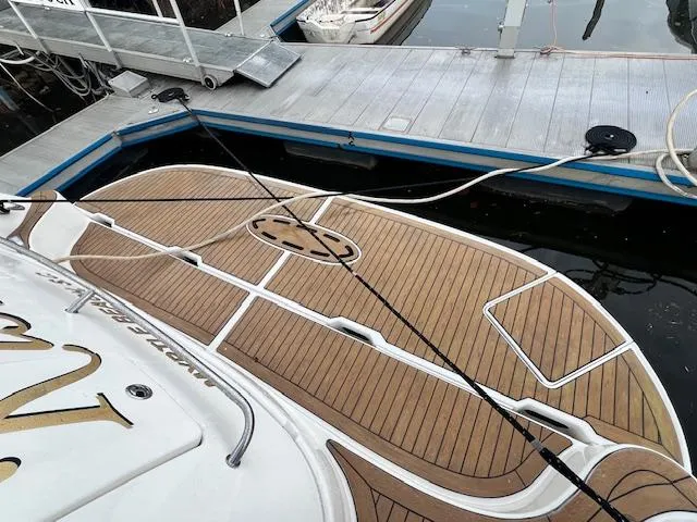 Slide: The Image of 2005 Sea Ray 500 Sundancer docked, featuring a spacious teak swim platform. - 36