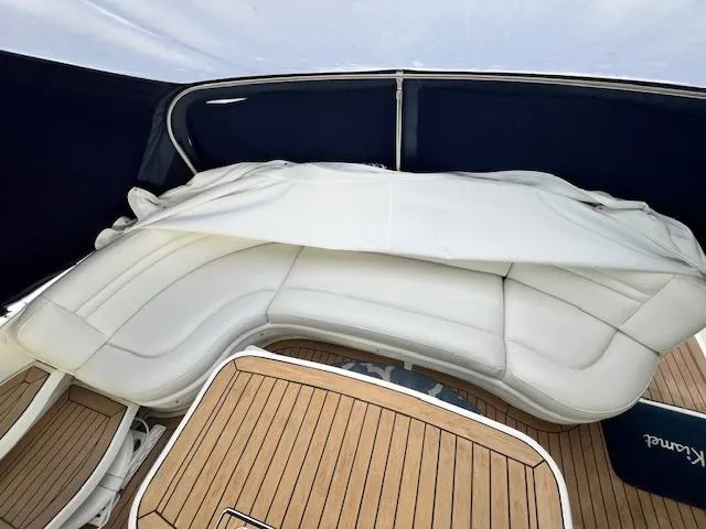 Slide: The Image of 2005 Sea Ray 500 Sundancer boat with white leather seating and teak flooring. - 37
