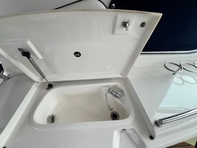 Slide: The Image of Open sink compartment on 2005 Sea Ray 500 Sundancer yacht deck. - 41