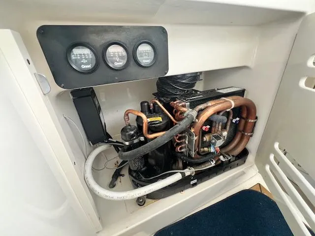 Slide: The Image of Engine compartment of a 2005 Sea Ray 500 Sundancer with gauges and piping visible. - 44