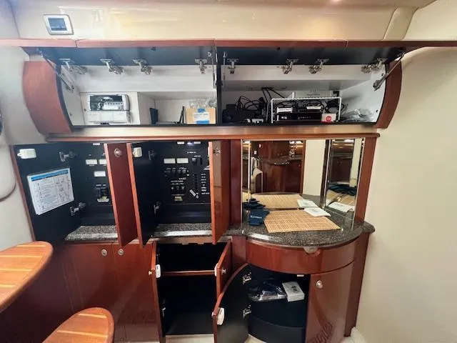 Slide: The Image of Interior of 2005 Sea Ray 500 Sundancer yacht with open cabinets and electronic equipment. - 46