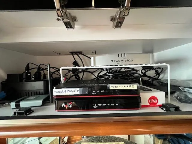 Slide: The Image of Electronics setup in a 2005 Sea Ray 500 Sundancer, featuring TracVision and Dish Wally equipment. - 47