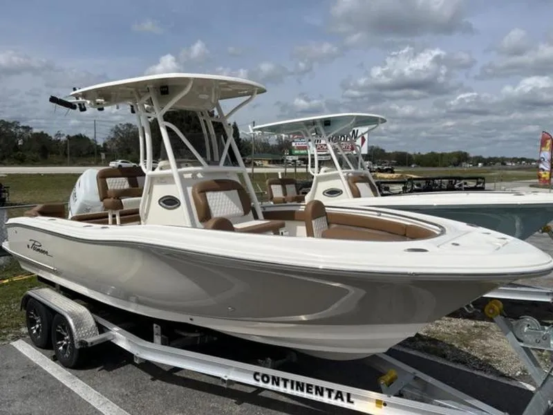 Slide: The Image of 2024 Pioneer Islander 222 boat on trailer under cloudy sky. - 12