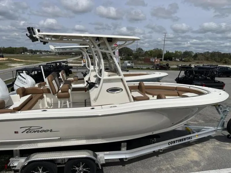 Slide: The Image of 2024 Pioneer Islander 222 boat on trailer, featuring sleek design and spacious seating. - 13