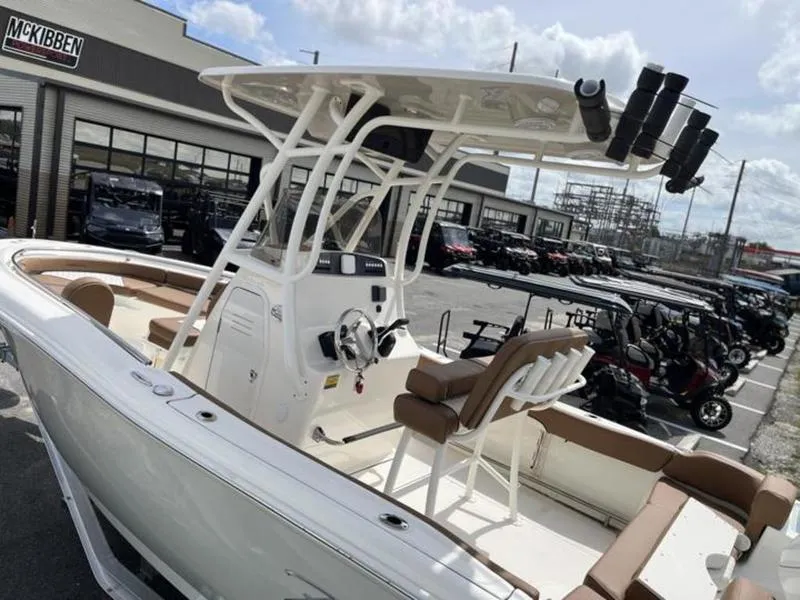 Slide: The Image of 2024 Pioneer Islander 222 boat with seating, parked at dealership. - 18