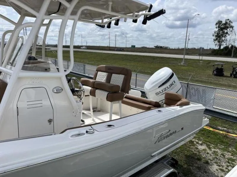 Slide: The Image of 2024 Pioneer Islander 222 boat with Suzuki outboard motor, parked on a trailer. - 19