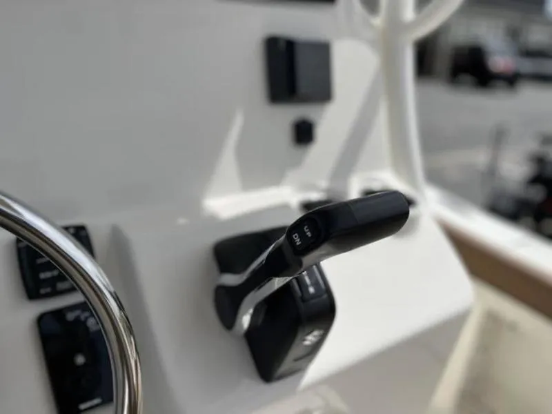 Slide: The Image of Close-up of 2024 Pioneer Islander 222 boat controls and steering wheel. - 2