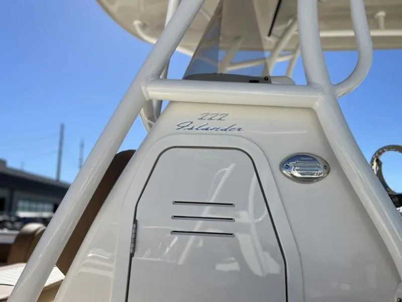 Slide: The Image of 2024 Pioneer Islander 222 boat, close-up of sleek white console design. - 24