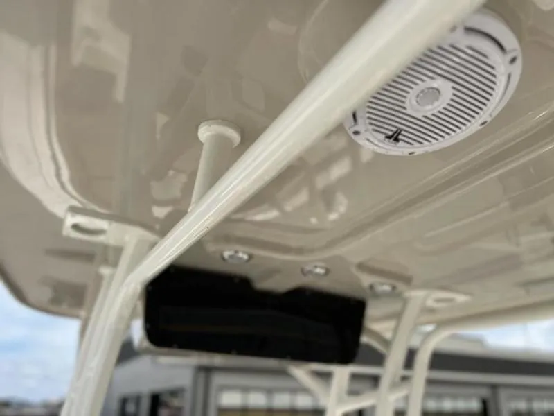 Slide: The Image of 2024 Pioneer Islander 222 boat interior ceiling with speaker and rod holder. - 4