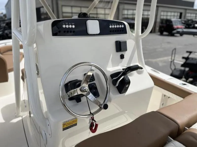 Slide: The Image of 2024 Pioneer Islander 222 boat console with steering wheel and controls. - 5