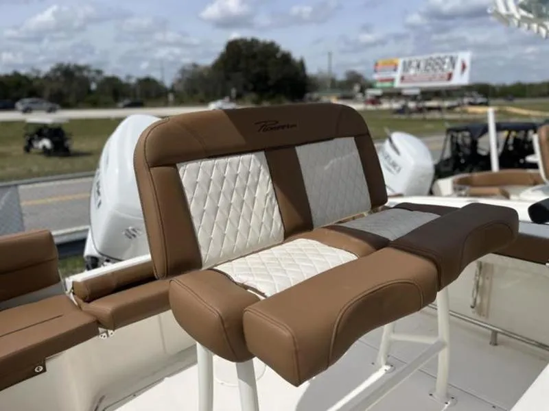 Slide: The Image of 2024 Pioneer Islander 222 boat with tan and white cushioned seating. - 6