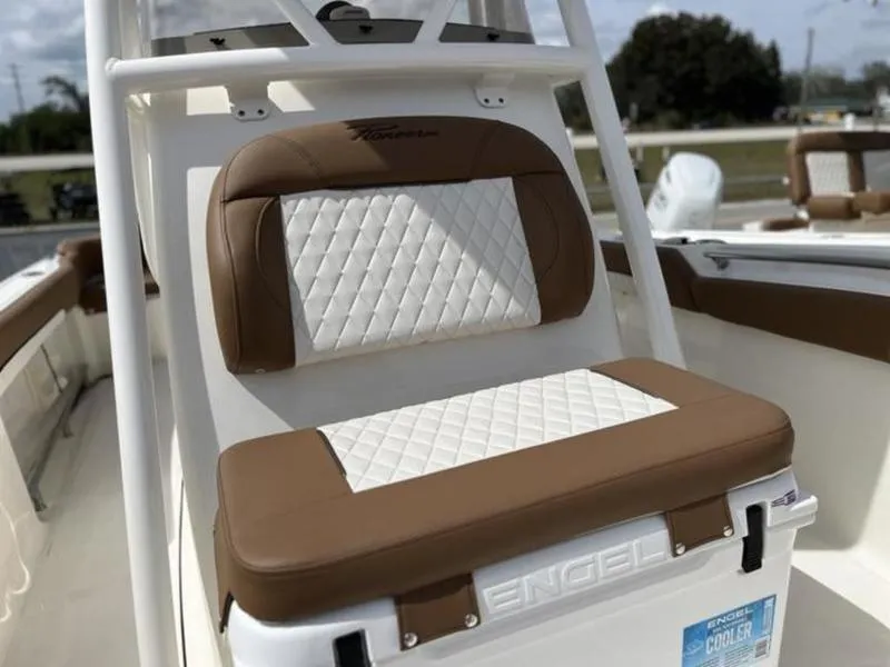 Slide: The Image of 2024 Pioneer Islander 222 boat seat with brown and white quilted design. - 8