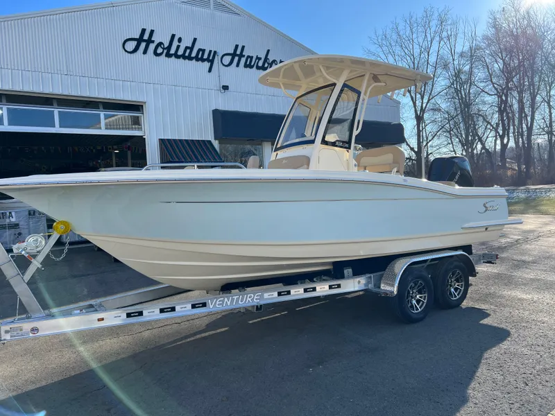 The Image of 2024 Scout 215 XSF boat on trailer at Holiday Harbor dealership. - 0