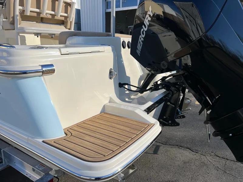 Slide: The Image of 2024 Scout 215 XSF boat with Mercury engine and teak swim platform. - 10