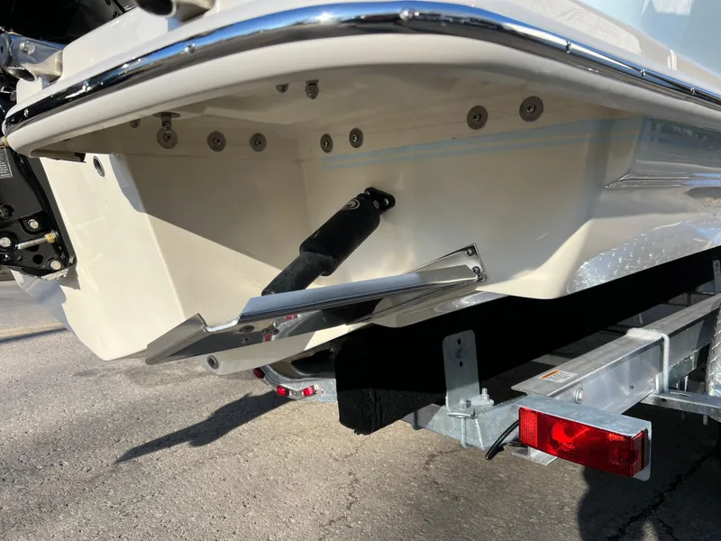 Slide: The Image of 2024 Scout 215 XSF boat on trailer, rear view showing trim tabs and hull details. - 14
