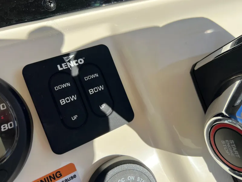 Slide: The Image of Lenco trim tab controls on 2024 Scout 215 XSF boat dashboard. - 18