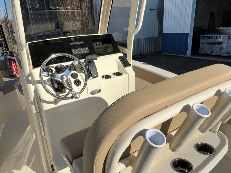 Slide: The Image of 2024 Scout 215 XSF boat interior with steering wheel and seating. - 22