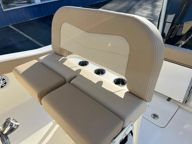 Slide: The Image of 2024 Scout 215 XSF boat seating with cup holders and beige upholstery. - 25