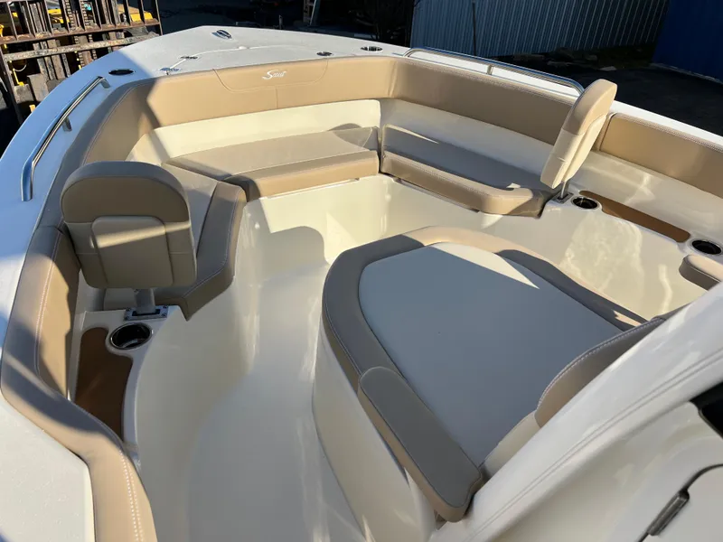 Slide: The Image of 2024 Scout 215 XSF boat interior with beige seating and cup holders. - 26
