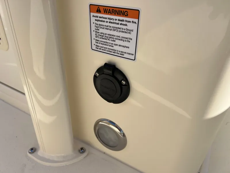 Slide: The Image of 2024 Scout 215 XSF boat warning label and electrical outlet. - 40