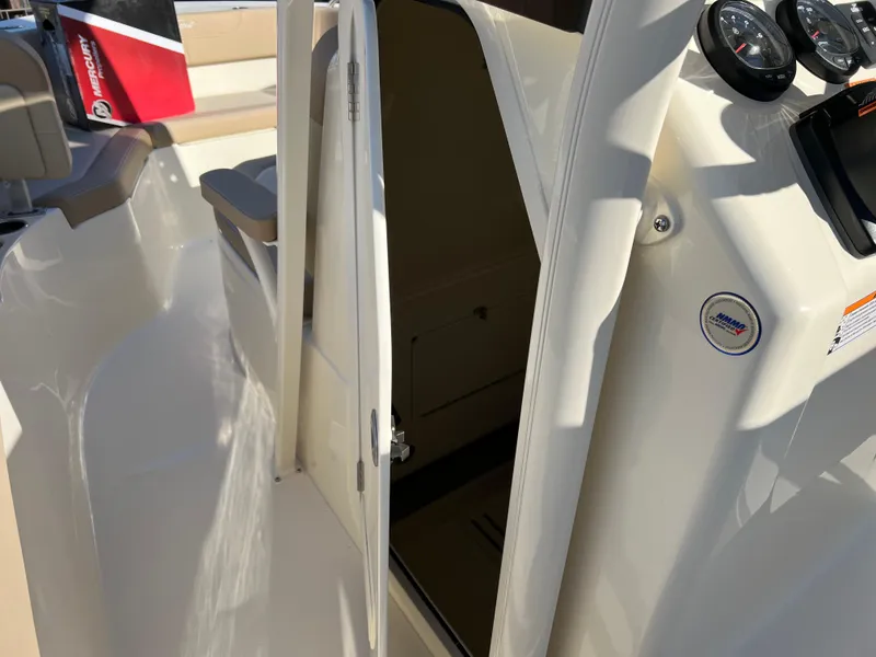 Slide: The Image of 2024 Scout 215 XSF boat interior with open cabin door and dashboard gauges. - 46