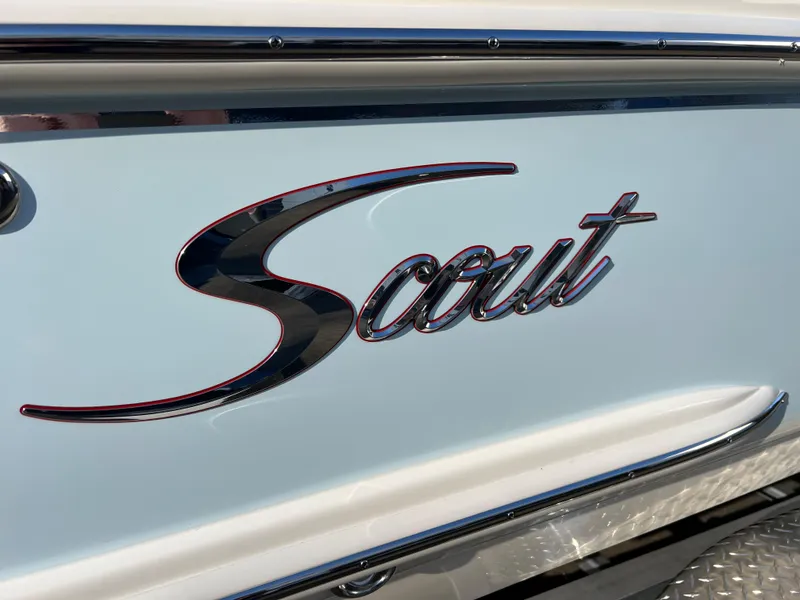 Slide: The Image of 2024 Scout 215 XSF boat logo on sleek white surface. - 5