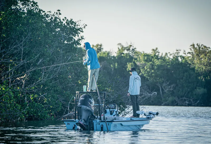 Slide: The Image of Two people fishing on a 2024 Cayo Boatworks 180 in a mangrove area. - 10