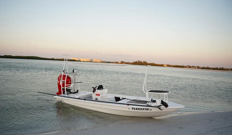 Slide: The Image of 2024 Cayo Boatworks 180 skiff on a serene beach at sunset. - 16