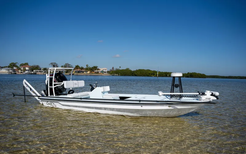 Slide: The Image of 2024 Cayo Boatworks 180 in shallow water with clear blue sky. - 21