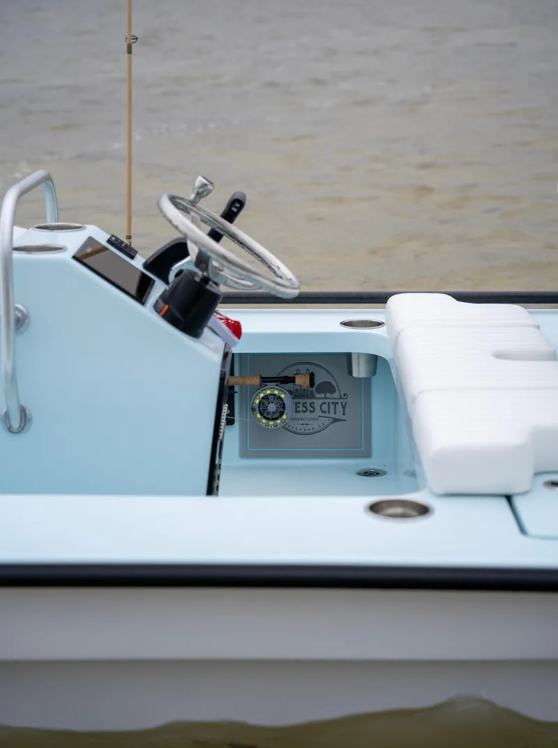 Slide: The Image of 2024 Cayo Boatworks 180, light blue interior, steering console, and white seating. - 3